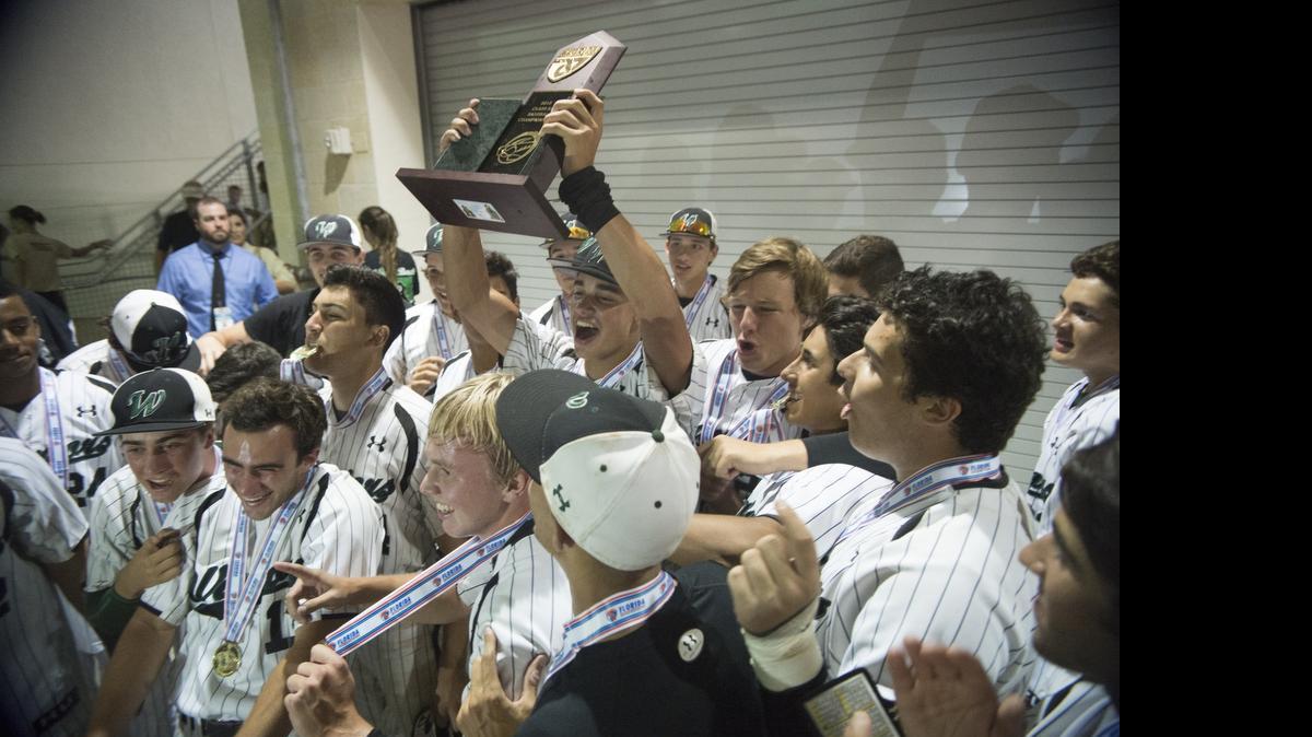 
Westminster Christian players hoist the Class 3A championship trophy after beating North Florida Christian 7-2 at JetBlue Park in Fort Myers on Tuesday, May 19, 2015. 
