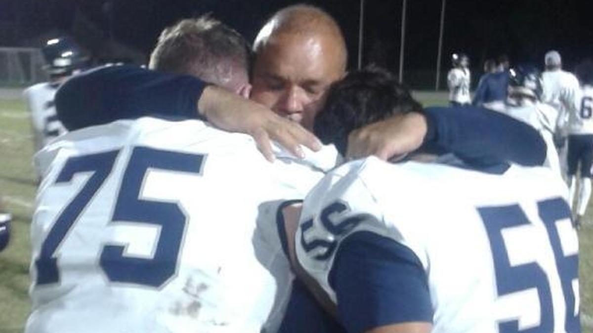 University School coach Daniel Luque shares an emotional moment with two of his seniors, Jeremy Czetenda (left) and Bradley Lanitchford after the Friday loss.