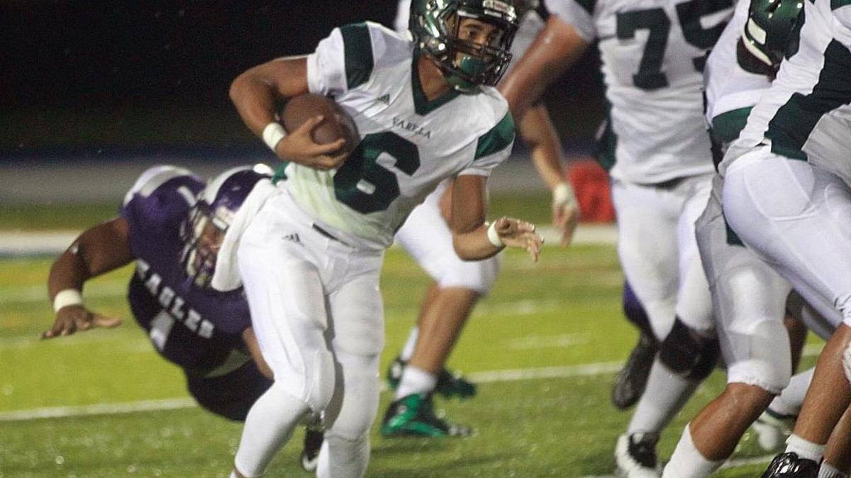 
Varela’s Jonathan Aburto (6) runs for yards in their game against Southwest at Tropical Park in Miami on Sept. 18, 2015.
