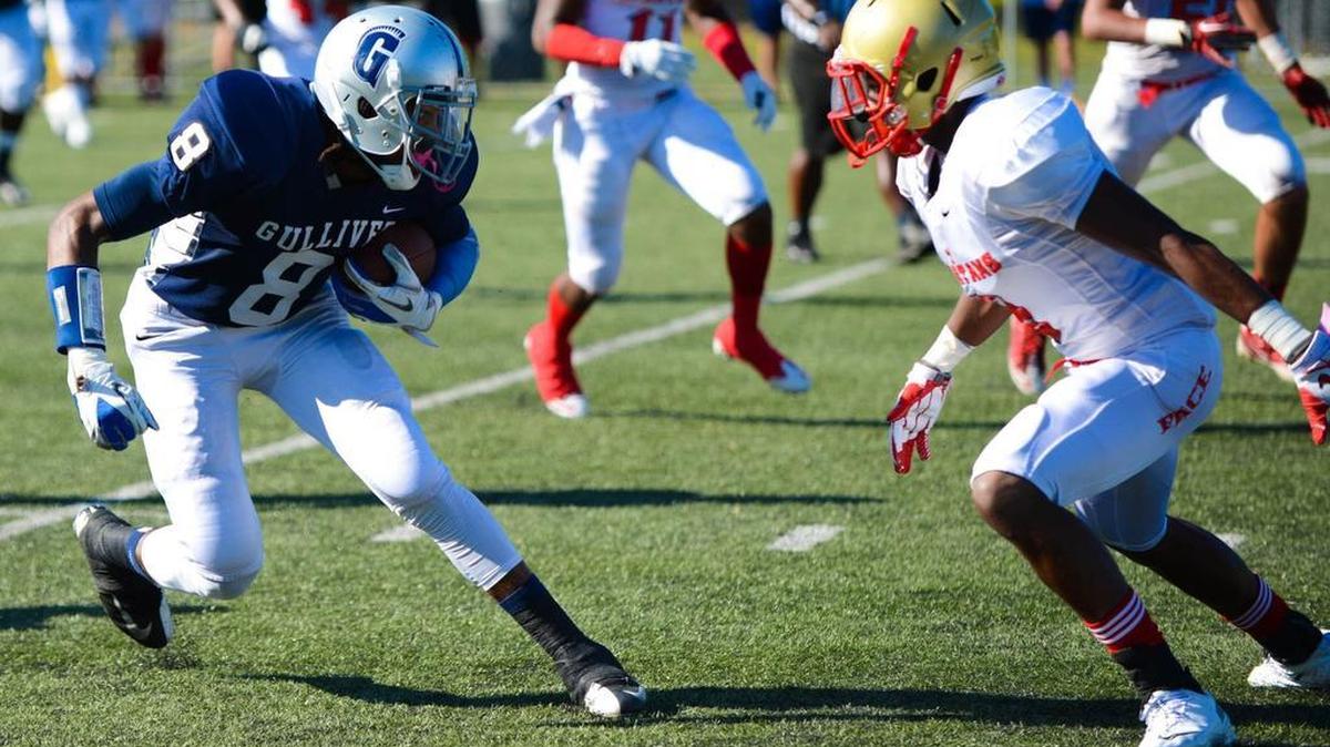 
Gulliver Prep’s Dionte Mullins tries to elude a Pace defender during a game Friday, Nov. 1, 2014. 
