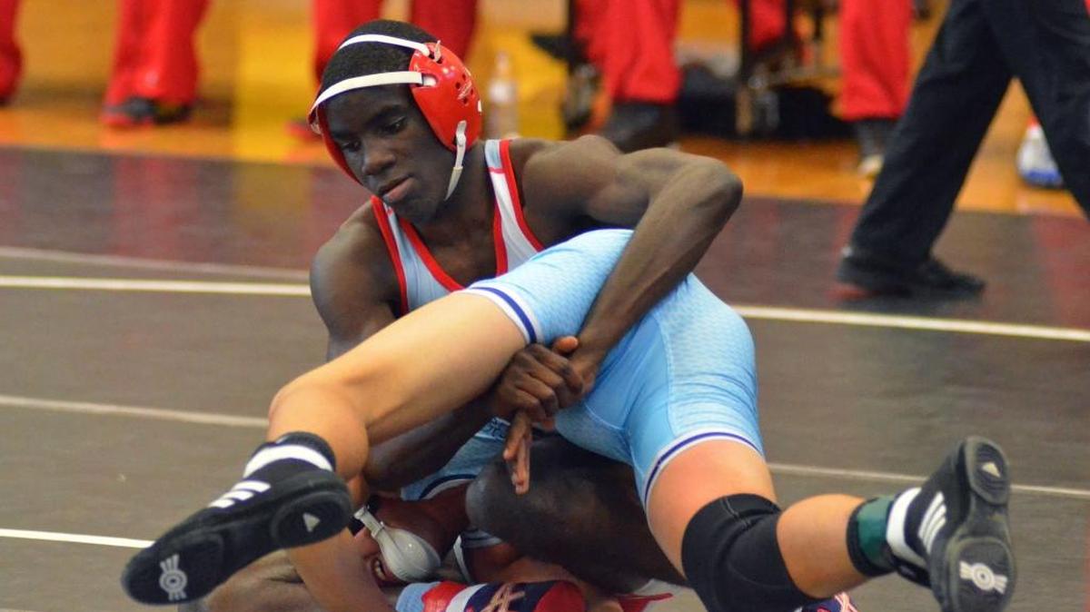 Cardinal Gibbons’ Allen Bryant ties-up Somerset Academy’s JSU Perez during a 138-pound match at the first-ever FHSAA Duals Class 1A state quarterfinals on Friday at Kissimmee Osceola High School. Bryant won with a 17-2 tech fall.