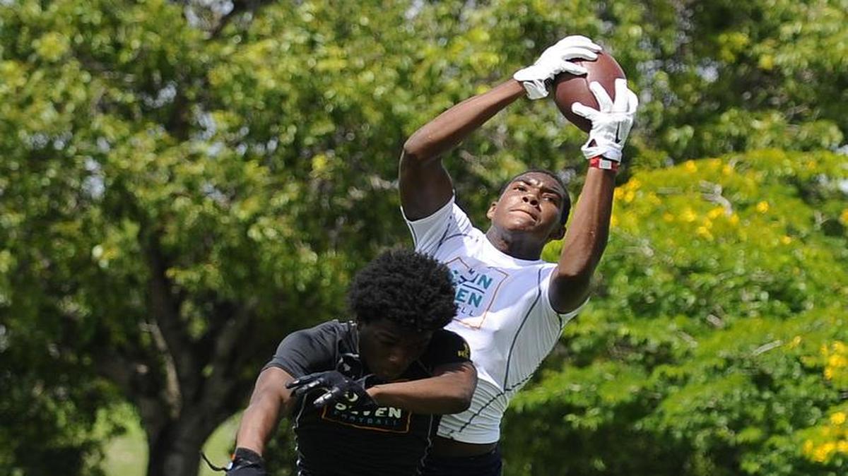 Palmetto high school junior wide receiver Ivan Thomas makes a mid air catch over a defender for a touchdown during the 9th annual 7 on 7 high school football tournament hosted by the Miami Dolphins at Central Park on June 25, 2016. Approximately 50 high schools across the state of Florida participate in the weekend long tournament.