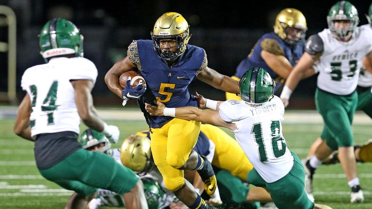 St Thomas Aquinas HS Daniel Carter (5) stiff-arms Venice HS Cristian George in the first quarter at St Thomas Aquinas HS in Fort Lauderdale, Florida, Friday, November, 30, 2018. St. Thomas won 38-13.