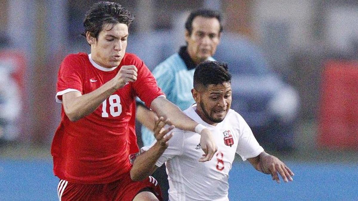 MAST Academy's Julian Botero (18) challenges Miami Beach's David Cuervo (8) for the ball during the GMAC boys' soccer final game on Thursday, January 25, 2018 at Traz Powell Stadium in Miami.