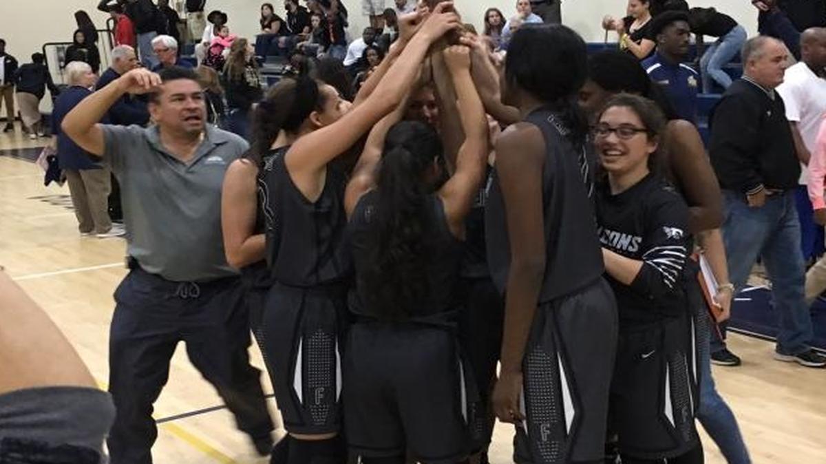 Ferguson players celebrate after finally defeating two-time defending state champion Miami High 44-38 on Friday, Feb. 12, 2016 at the Miami High gym.