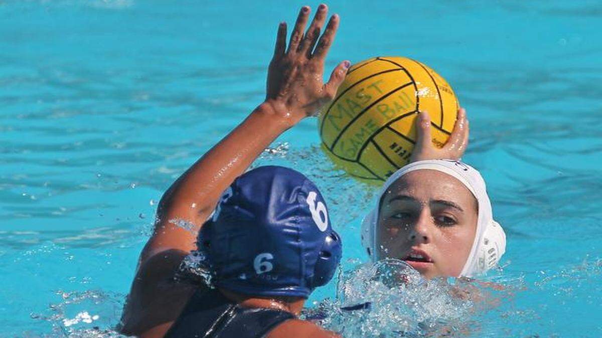 
MAST Academy’s Cara Mullery attempts a shot over TERRA High School’s Samantha Esposito during the GMAC water polo finals at Miami Dade College North Campus Aquatic Center on Wednesday, April 1, 2015.
