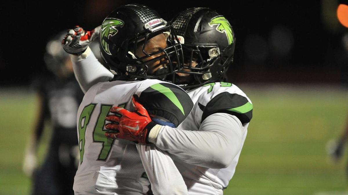 Flanagan’s Chad Joseph, left, celebrates with a teammate after Joseph scores a touchdown against Columbus during a Class 8A state semifinal at Tropical Park in Miami on Friday, Dec. 4, 2015.