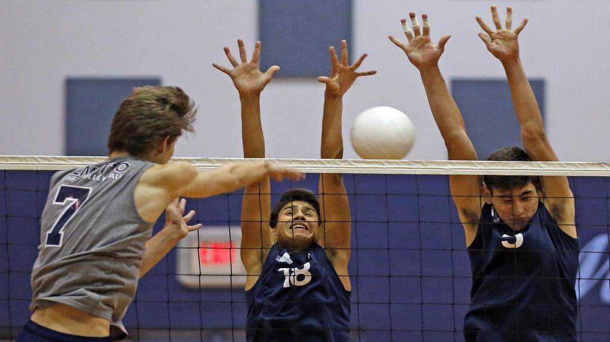 
Palmetto’s Devin Decker returns a ball into Mourning’s Santiago Triana and Will Zuluaga in the GMAC volleyball championship at Palmetto High School, April 21, 2015.
