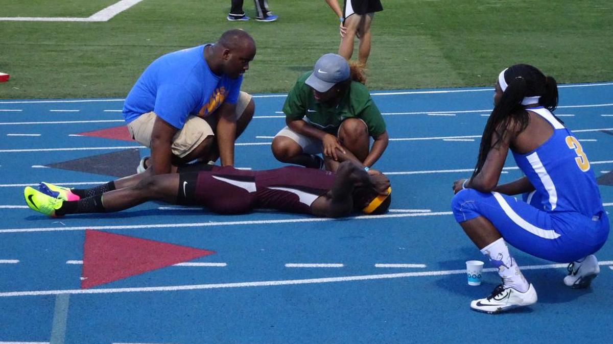Norland sophomore Tyrese Cooper is tended to by trainers moments after winning the 200 meter dash in the Region 4-3A meet at Traz Powell Stadium on Friday April 28, 2017. Cooper won the 100, 200 and 400 meter races.
