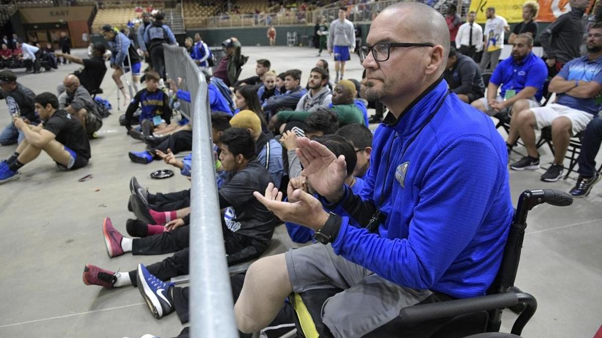 South Dade principal Javier Perez watches one of the school's championship matches during the FHSAA State Wrestling Finals, Sat., March 4, 2017, in Kissimmee, Fla.