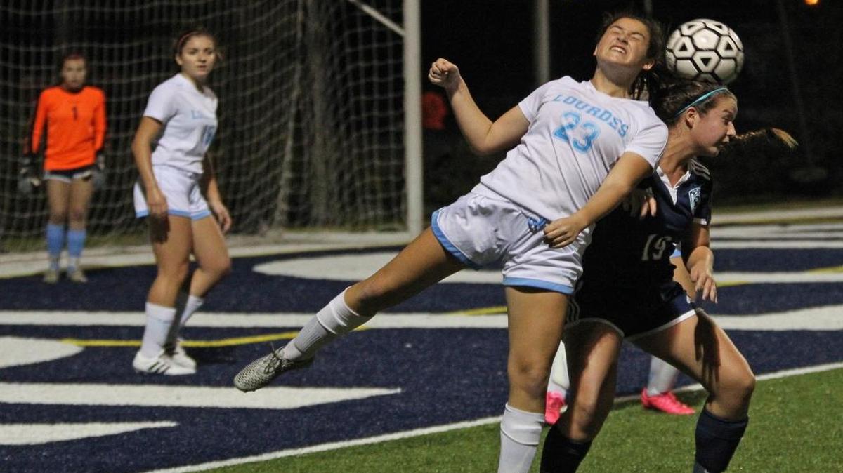 Lourdes’ Sofia Hillman (23) and Palmetto’s Sydney Denkert battle for the ball during a Region 4-5A girls’ soccer semifinal Tuesday, January 26, 2016, at Columbus High.