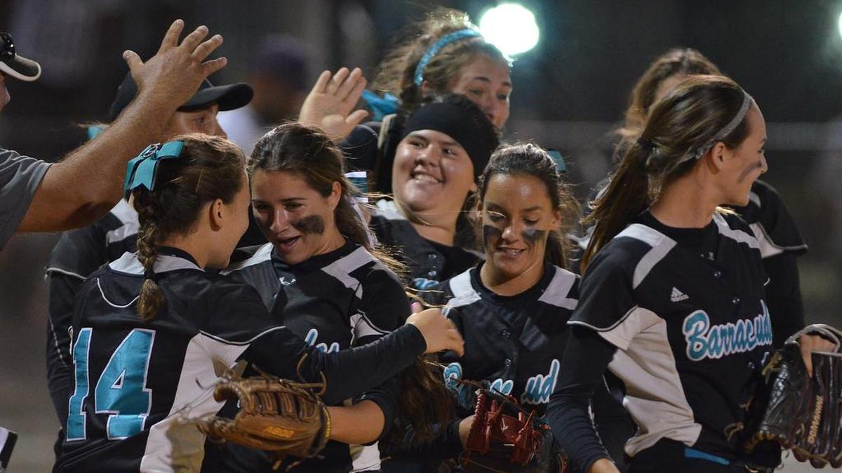 The Coral Reef softball team celebrates after beating Southwest in a Region 4-9A quarterfinal on Wednesday night.