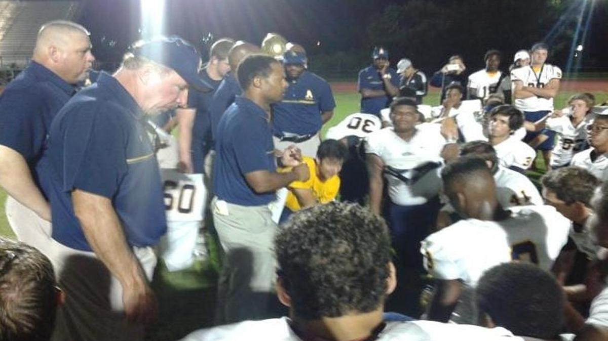 St. Thomas Aquinas coach Roger Harriott talks to his tam after a 51-0 win over Dillard.