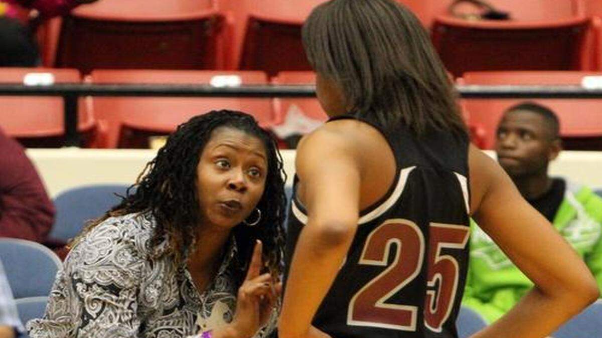 Norland girls’ basketball coach Carla Harris gives Tyana Williams a few pointers during a game against Pine Forest in a Class 6A semifinal Feb. 21, 2014 in Lakeland.