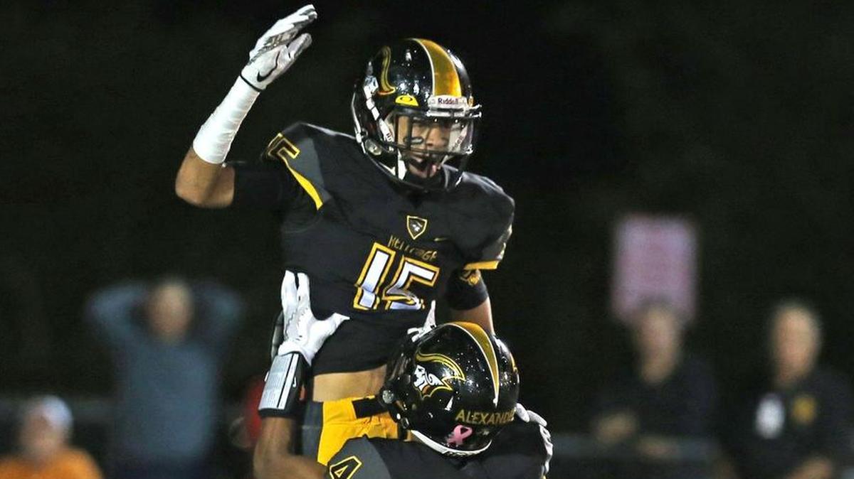 American Heritage’s Marcus Lodge (15) jumps in the air after scoring a first-quarter touchdown as Josh Alexander (4) celebrates with him on Friday.