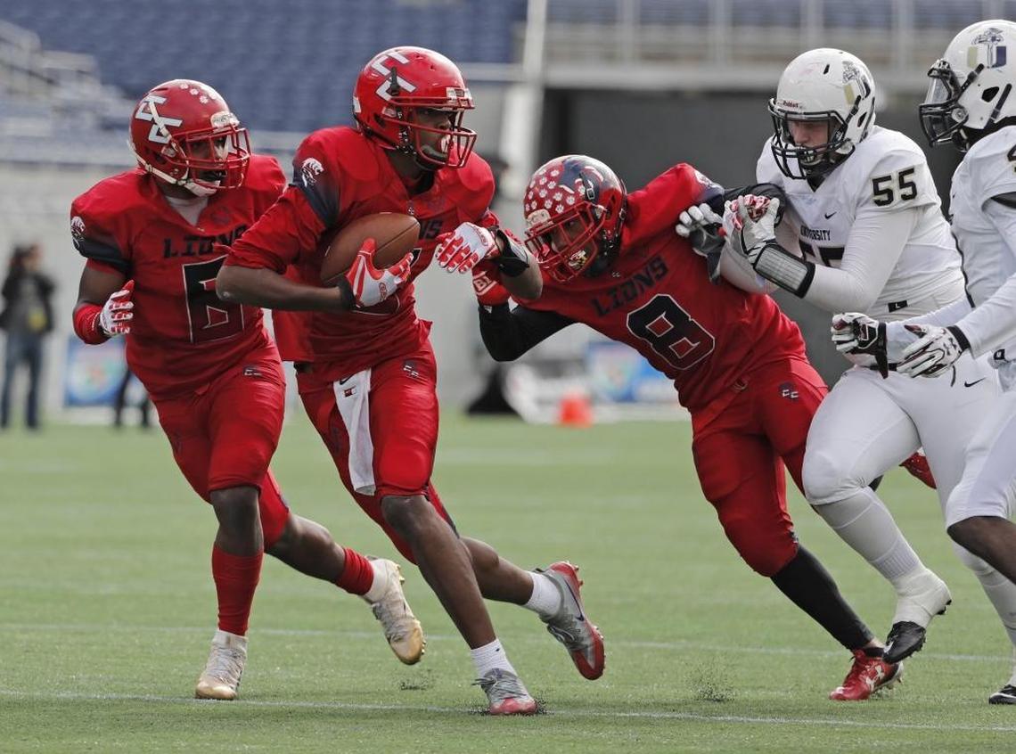 Champagnat’s Gregory Rousseau (5) picks up a blocked punt as Champagnat plays Jacksonville University Christian for the state football title at Camping World Stadium in Orlando on Fri., Dec. 9, 2016