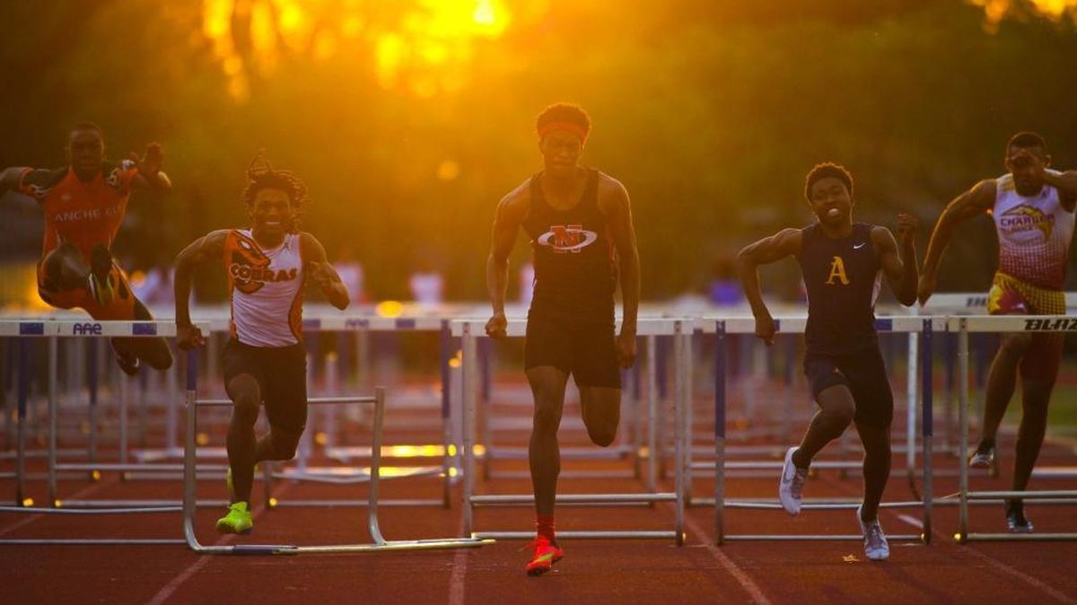 Northeast’s Damion Thomas, center, wins the boys’ 110 meter hurdles during the BCAA track and field championship at Dillard High in Fort Lauderdale on Friday, March 18, 2016.