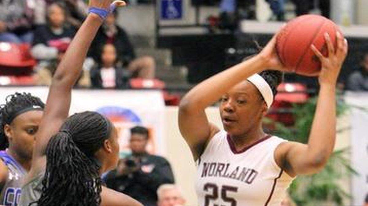 
Norland’s Tyana Williams looks to get rid of the ball as a Barron Collier player defends during the FHSAA Class 6A girls’ basketball state semifinal at The Lakeland Center on Friday, Feb. 20, 2015. 
