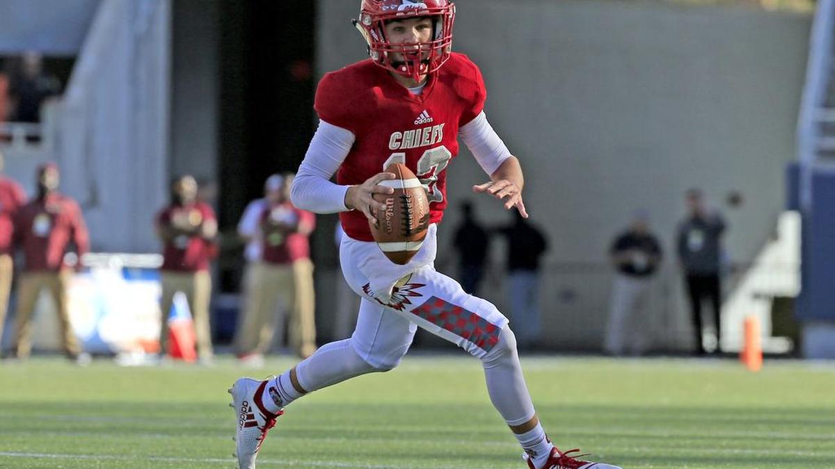 Cardinal Gibbons quarterback Brody Palhegyi (12) looks to pass in the first quarter as Cardinal Gibbons plays North Marion in the Florida High School Athletic Association State Class 5A Championship at Camping World Stadium in Orlando on Friday, December 7, 2018.