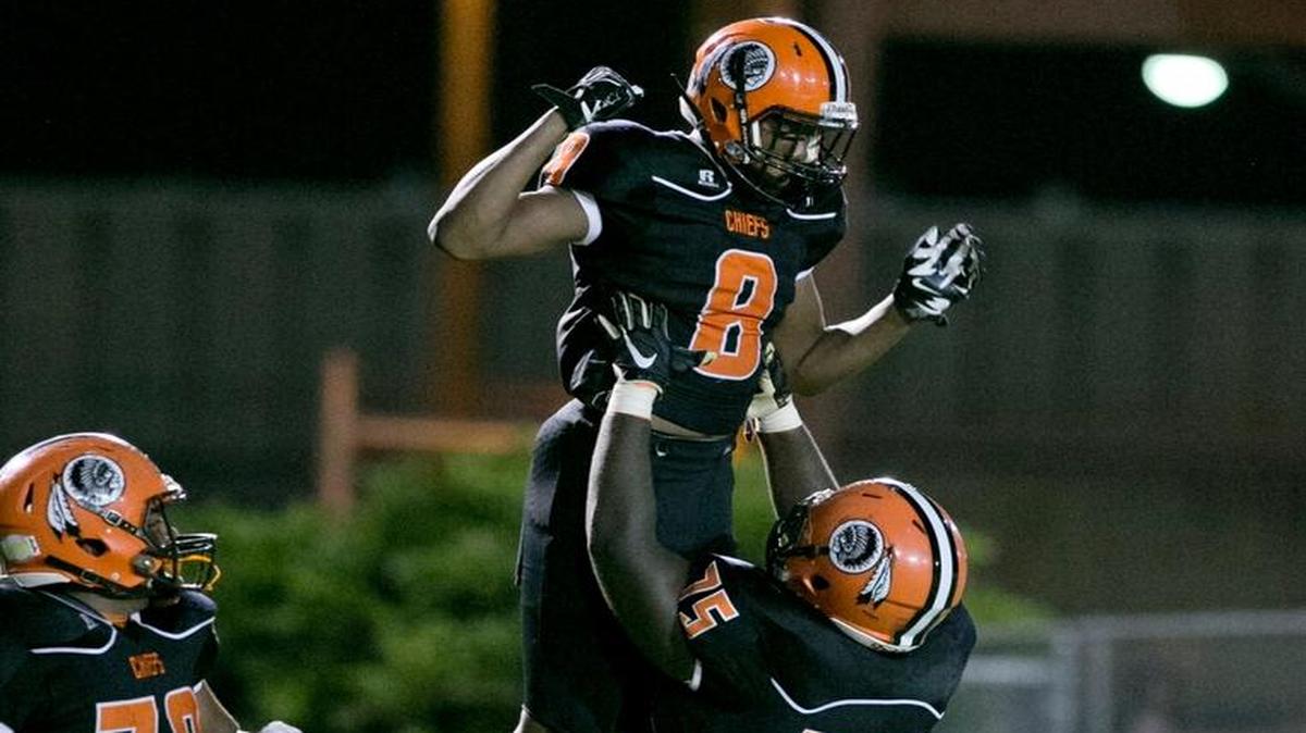 Carol City's Kevaughn Dingle (8) and Dante Rose (75) celebrate in the end zone after Dingle scores during a high school football playoff game against Dillard at Traz Powell Stadium on Friday, November 13, 2015.