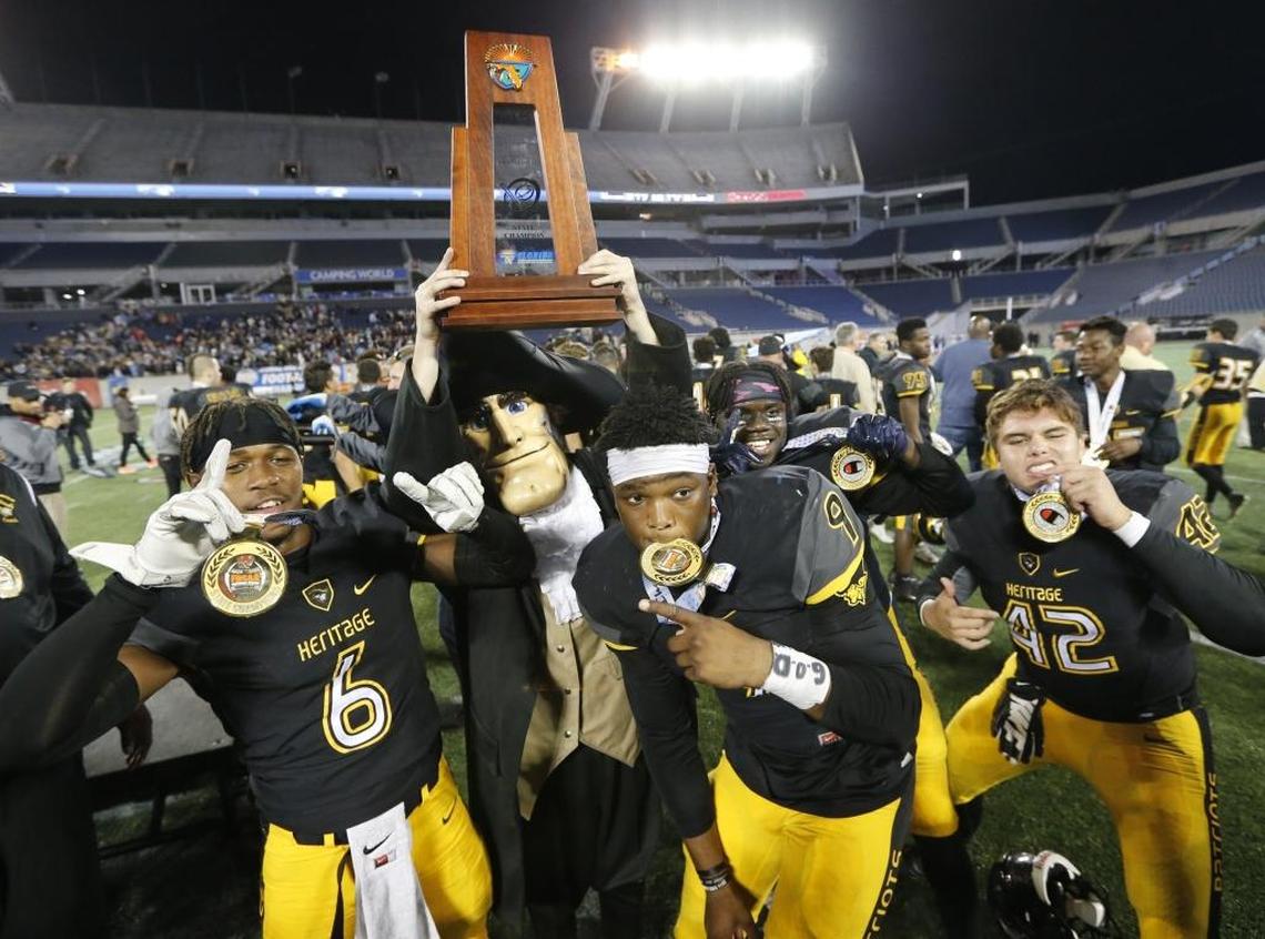American Heritage players Laress Nelson (6), Andrew Chatfield (9) and Blake Judge (42) with the team mascot as American Heritage celebrates after defeating Ponte Vedra for a state football title at Camping World Stadium in Orlando on Friday, December 9, 2016.