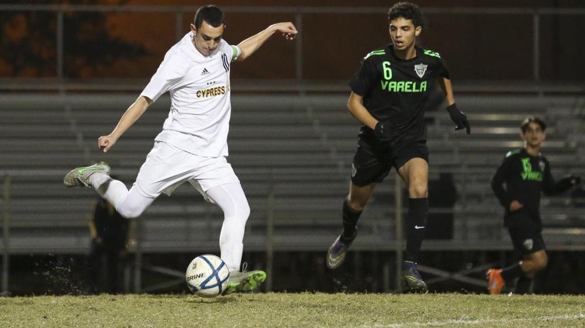 Cypress Bay’s Jake Fuhrman (10) kicks the ball while Varela’s Haitam Chahti tries to block during the first half of the Region 4-5A boys’ soccer final in Weston on Feb. 5, 2016. Cypress Bay won 2-1 in the second overtime.