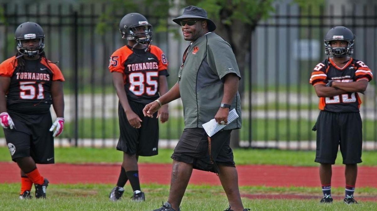 
Booker T. Washington's football head coach, Earl Tillman, looks over his team during practice at Booker T. Washington High School on Monday, August 3, 2015. 
