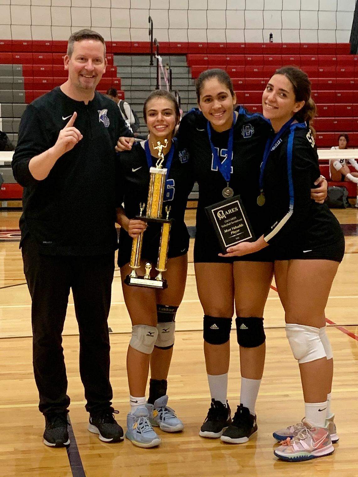 Divine Savior volleyball coach Matt Willems with top players Kayla Lopes, Carola Rodriguez and Thalia Iglesias.
