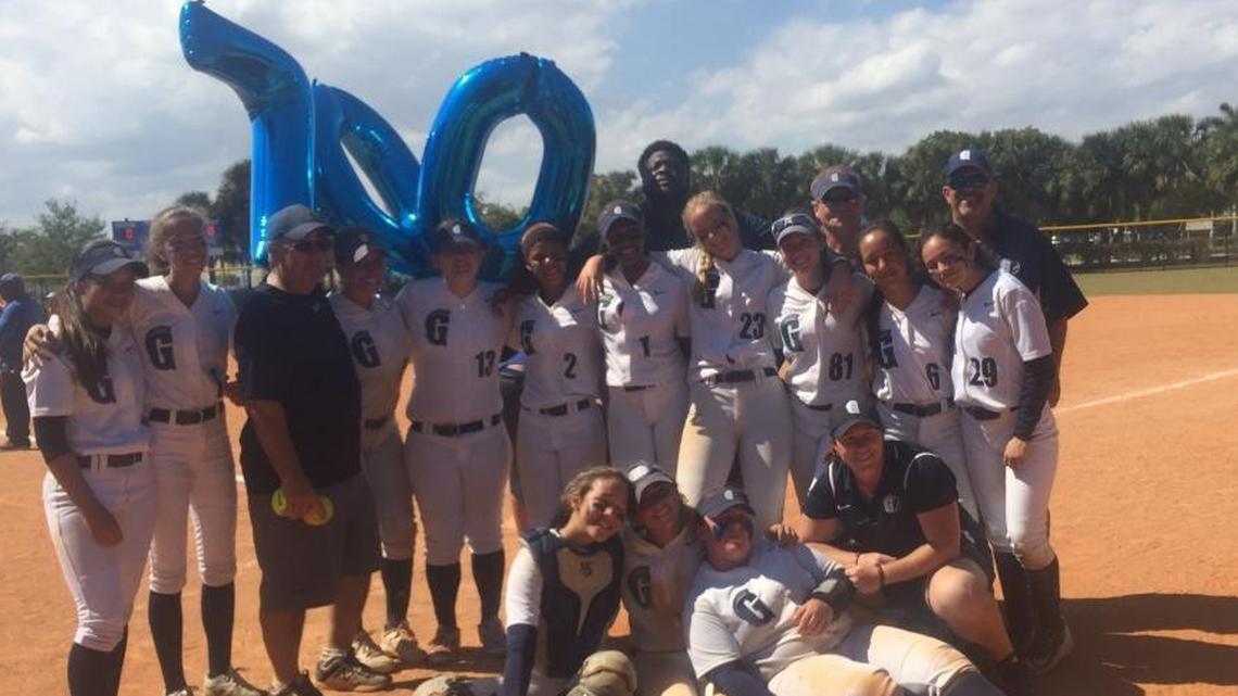 Gulliver softball coach Mark Schusterman (left, wearing dark blue shirt), who has guided the Raiders to six state championships over more than three decades, recorded his 700th career win on Saturday at the SlamFest tournament in Palmetto Bay, Fla.