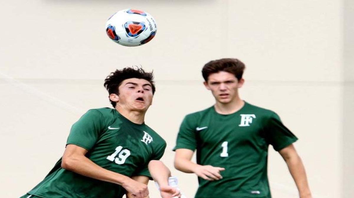 Doral’s Gianlucca Rossi (14) battles Marcus Murphy of Orange Park Fleming Island for the ball in the Class 4A boys’ soccer state championship game Saturday in DeLand.