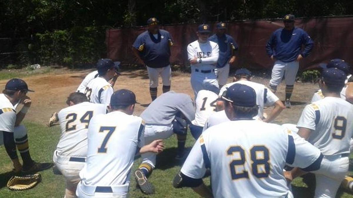 Belen coach Jerry Albert tries to console stunned Belen players after losing on 2-out error in 7th.