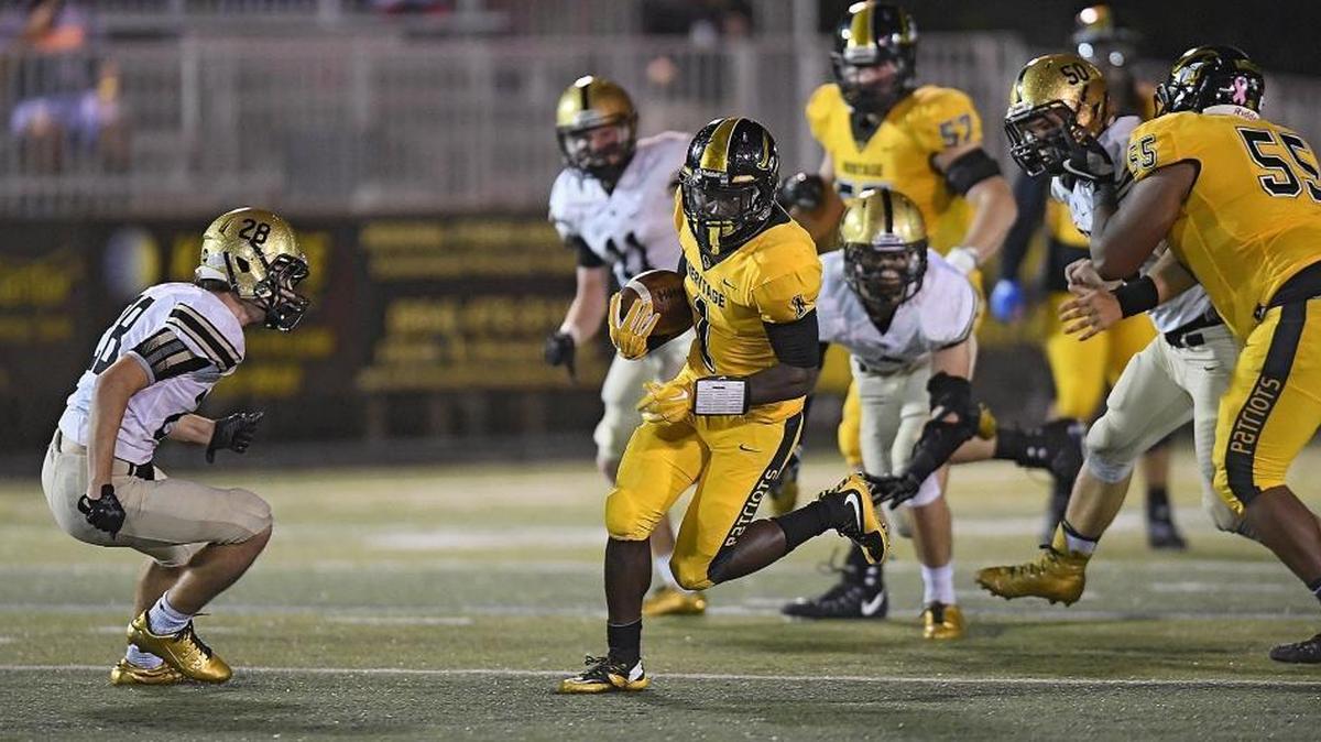 American Heritage running back Miles Jones runs for a touchdown past Bishop Moore's Channing Stott during the first half of their game on Friday, Nov. 17, 2017.