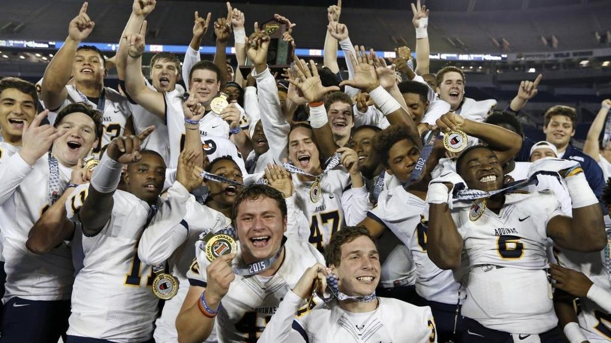 St. Thomas Aquinas football players celebrate their second consecutive state championship following a 45-10 win over Viera in Orlando on December 11, 2015.