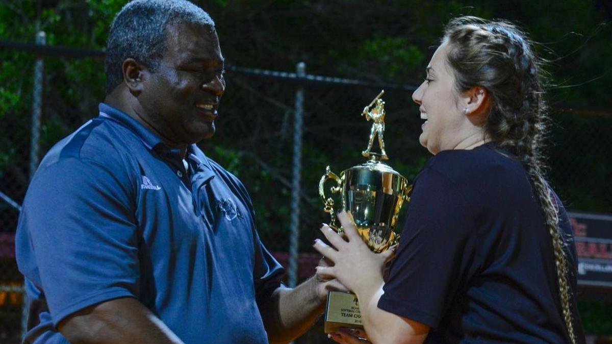 A Pembroke Pines Charter player receives the championship trophy after winning the BCAA championship softball game at Silver Lakes Park South in Pembroke Pines, Fla. on Thurs., April 7.