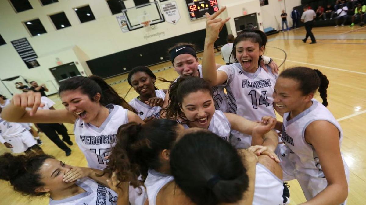 Ferguson players cheer after defeating Miami High during a girls' basketball regional final in John A. Ferguson High School on Fri., Feb. 17, 2017. Ferguson won the game 52-34.