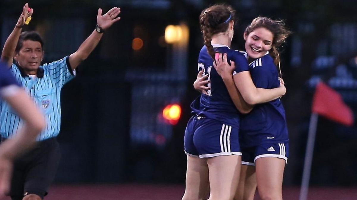 Palmetto High's Emily Lamas (right) celebrates a goal with teammate Gabrielle Pardo on Tues., Jan. 10, 2017 as Palmetto played Miami Beach in the GMAC county championship tournament.