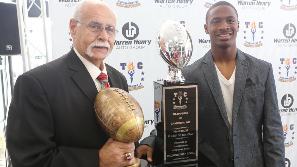 Monsignor Pace coach Joe Zaccheo and Miami Northwestern senior quarterback Chatarius “Tutu” Atwell during the presentation of South Florida Player and Coach of the Year Award at Warren Henry Auto Group Jaguar on Friday, Dec. 15, 2017.