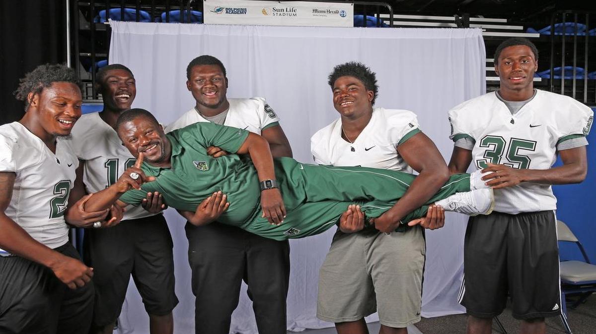 Miami Central players, left to right, Donovan Thompson, Jerrod Thomas, Navaughn Donaldson, Keir Thomas and Jamel Cook carry coach Roland Smith Jr. during a photo shoot at Nova Southeastern.

