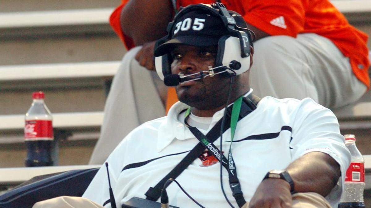 
Booker T. Washington coach Earl Tillman, relegated to the bleachers because of a severe leg injury, looks on during a game against Hamilton High School (Chandler, Ariz.) at Traz Powell Stadium in Miami on Aug. 29, 2008. 
