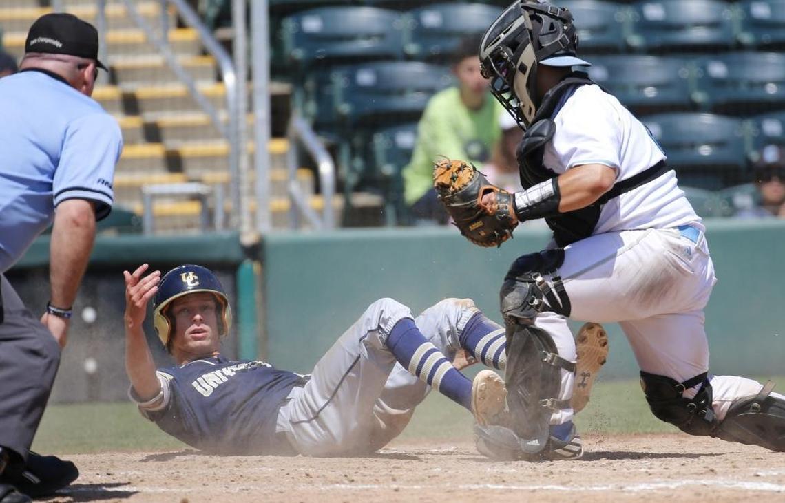 Archbishop Carroll's catcher Chris Fernandez (18) tags out University Christian's Cody Melton (23) in the 5th inning in Class 3A state semifinal at Centurylink Sports Complex - Hammond Stadium in Fort Myers on Fri., May 26, 2017.