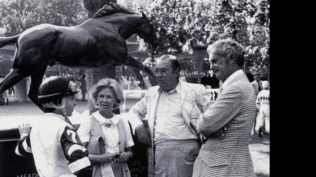 
From left: Jockey Steve Cauthen, Patrice Wolfson, trainer Laz Barrera and Louis Wolfson hold a conference at Belmont Park in front of a statue of Secretariat on Sept. 15, 1978. Louis and Patrice Wolfson owned Affirmed, the last horse to win the Triple Crown (1978). 
