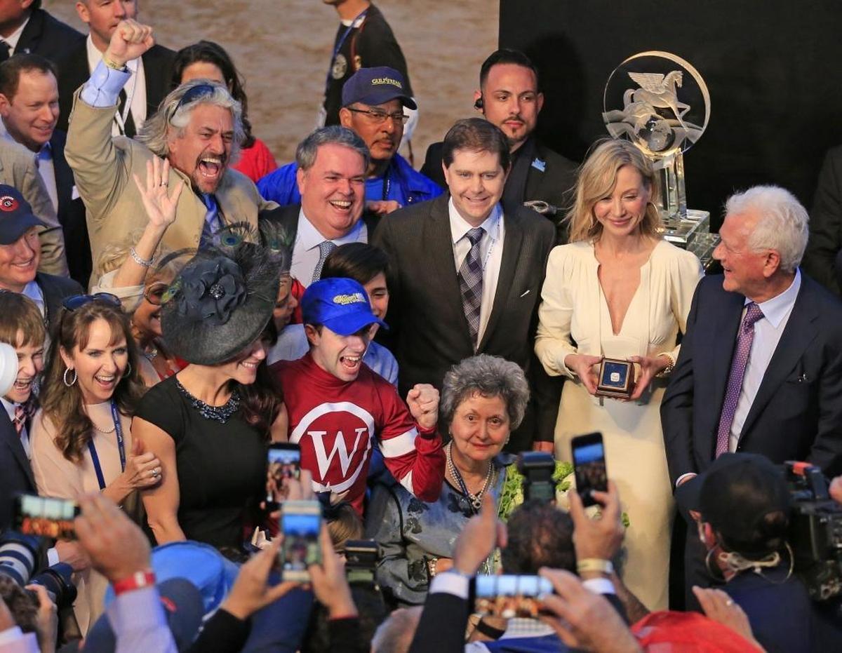 Jockey Florent Geroux pumps his fist as trainer Steve Asmussen does the same behind him at the winners circle after Gun Runner wins the second running of Pegasus World Cup Invitational at Gulfstream Park, Hallandale Beach on Saturday, Jan. 27, 2018.