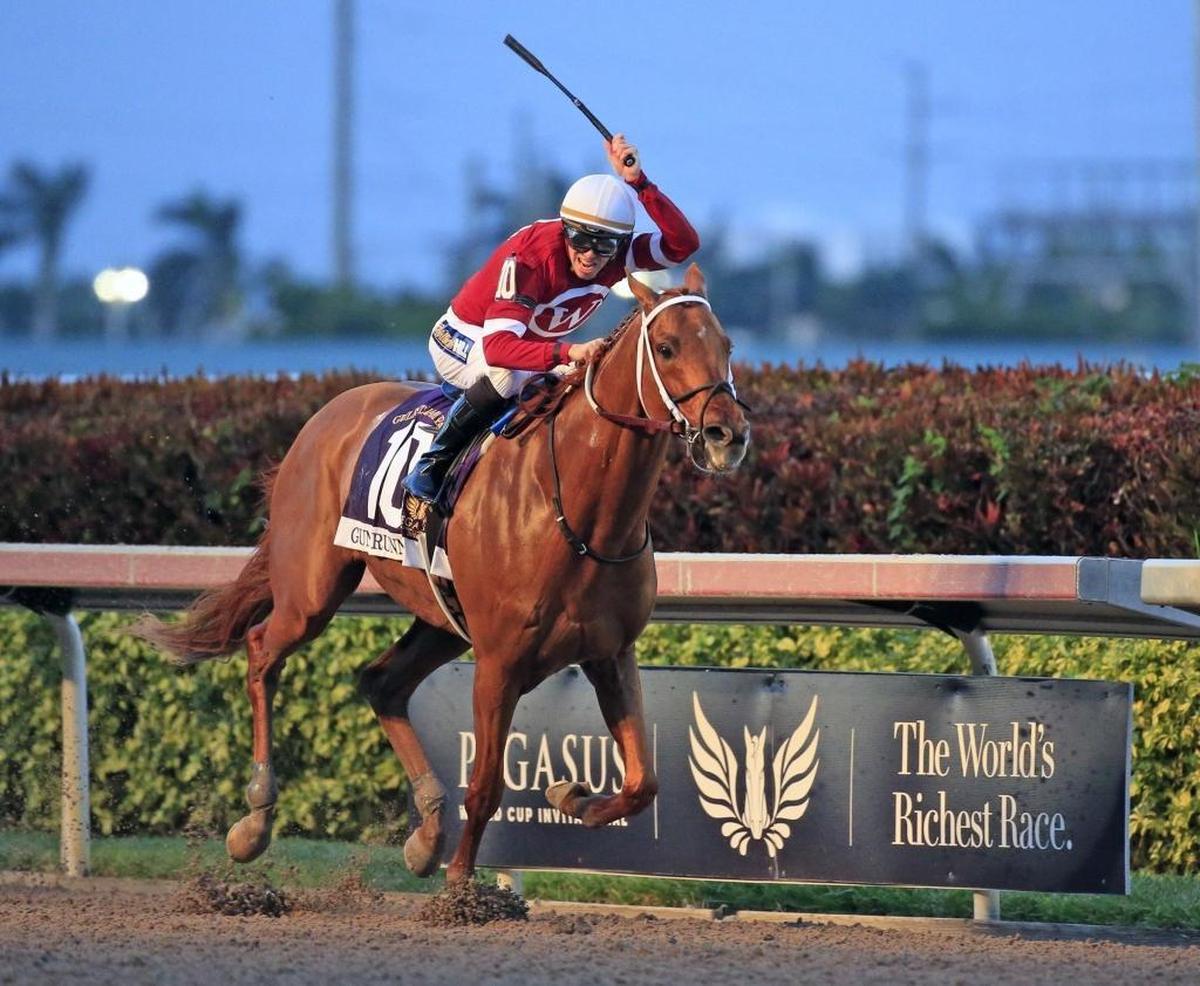 Gun Runner crosses the finish line as jockey Florent Geroux celebrates the win during the second running of Pegasus World Cup Invitational at Gulfstream Park, Hallandale Beach on Saturday, Jan. 27, 2018.