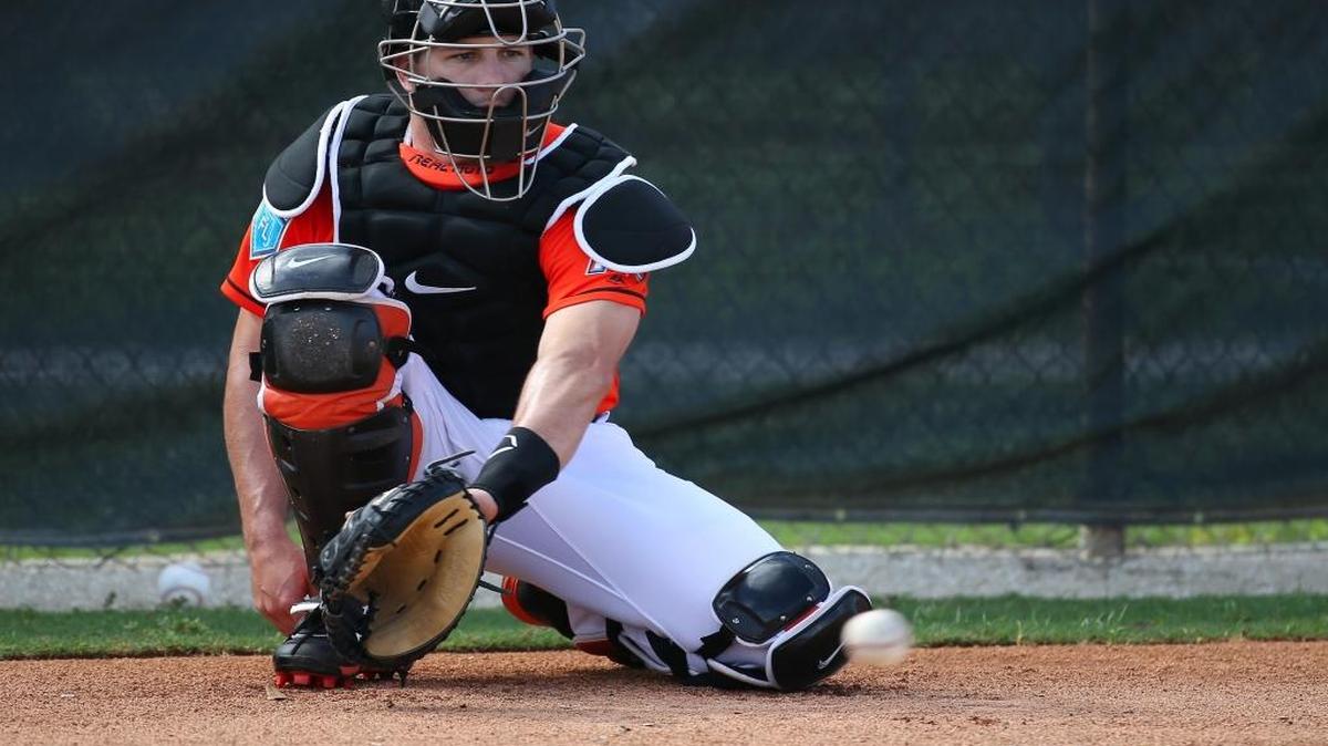 Miami Marlins catcher J.T. Realmuto fields a ball during the spring training baseball workouts for pitchers and catchers at Roger Dean Stadium on Wednesday in Jupiter.