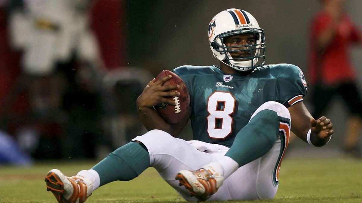 
Quarterback Daunte Culpepper #8 of the Miami Dolphins sits on the ground after being sacked by defensive tackle Anthony McFarland #92 of the Tampa Bay Buccaneers at Raymond James Stadium on August 19, 2006 in Tampa, Florida. 
