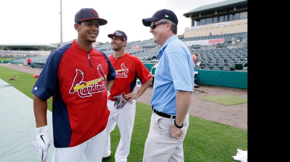 
FILE - In this Feb. 25, 2013, file photo, Houston Astros general manager Jeff Luhnow, right, talks to St. Louis Cardinals center fielder Jon Jay, left, and second baseman Daniel Descalso before an exhibition spring training baseball game in Jupiter, Fla. Major League Baseball says it is cooperating with a federal investigation into an illegal breach of the Astros' internal operations database, amid a report that the Cardinals were responsible for the hack. 
