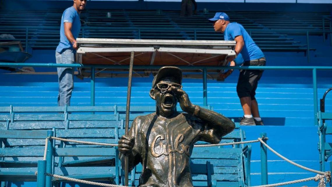 People work next to a statue of Cuban baseball fan and entertainer Armando Luis Torres Torres at the Latinoamericano stadium, where an exhibition will be played on March 22 between the Cuban national baseball team and the Tampa Bay Rays in Havana, Cuba.