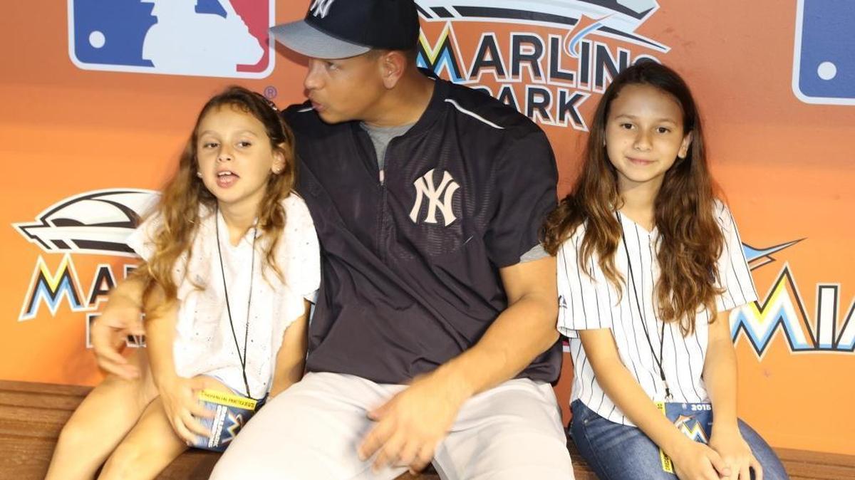 Alex Rodriguez sits in the New York Yankees dugout at Marlins Park with daugthers Ella Rodriguez (left) and Natasha Rodriguez (right) before a game against the Marlins in 2015.