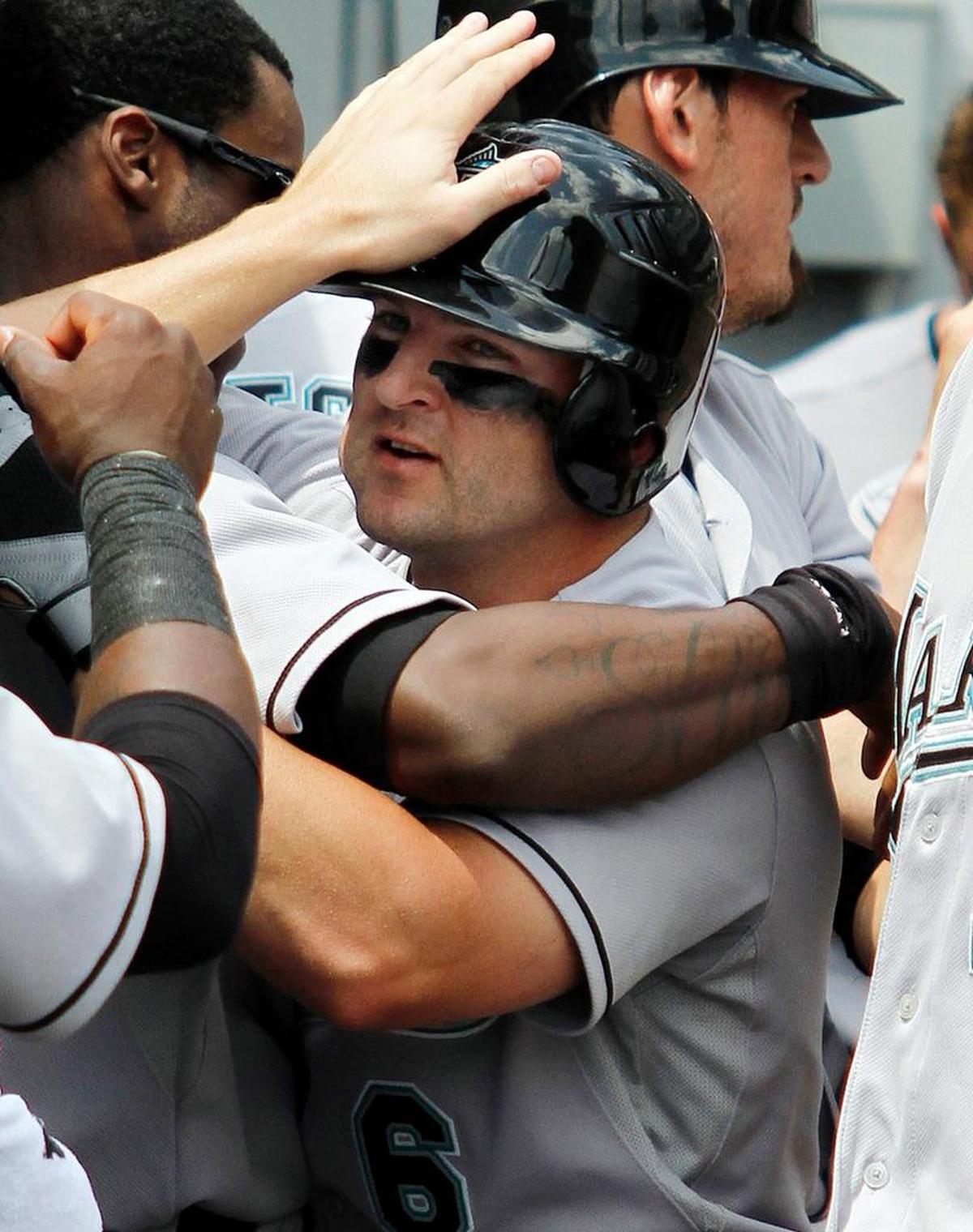 Florida’s Dan Uggla is congratulated in the dugout after hitting a two-run home run against the Chicago White Sox in 2010.