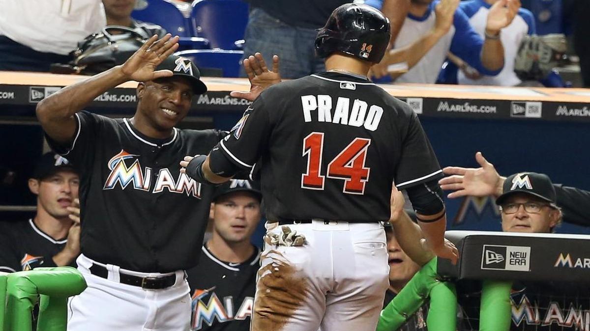 Miami Marlins' hitting coach Barry Bonds greets third baseman Martin Prado as he scored on an RBI single by right fielder Giancarlo Stanton in the sixth inning of the Miami Marlins and Philadelphia Phillies game at Marlins Park in Little Havana in Miami on Mon., July 26, 2016.